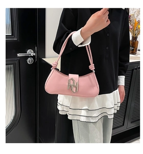 Pink patent leather underarm bag with silver metal logo and knotted cylindrical handle