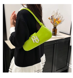 Detail of lime green crescent shoulder bag featuring silver buckle and knot strap detail