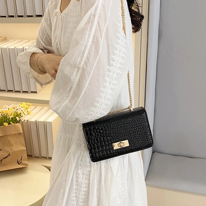 Classic black crocodile texture crossbody bag with gold hardware and chain strap
