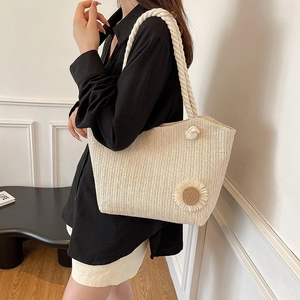 Beige woven straw tote bag with sunflower accent and thick rope handles for women