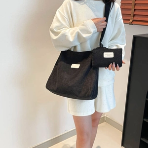 Black corduroy tote bag and matching pouch set with a minimalist design for daily commute