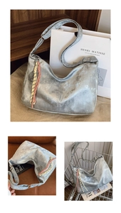 Detail of silver metallic hobo bag featuring tennis racket pendant and braided rope accents