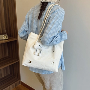 White fabric tote bag with butterfly appliques and plush cloud charm for women