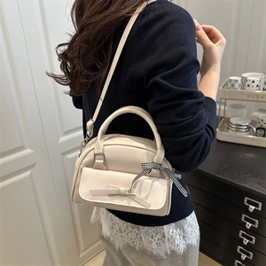 Creamy white square crossbody bag with bow pocket and plaid ribbon detail