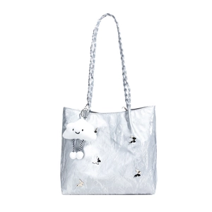 Metallic silver tote bag with braided handle and butterfly charms for women