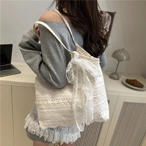 Elegant white lace tote bag with floral patterns and a large bow on shoulder