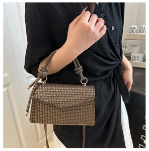 Détail du sac à main monogramme vintage avec poignée nouée et anneaux métalliques dorés
