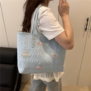 Chic light blue tote bag with colorful butterfly embroidery and embossed texture