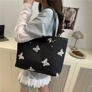 Stylish black tote bag with colorful butterfly embroidery and logo pattern for women