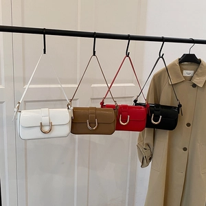 Retro style shoulder bags with horseshoe buckles in white, brown, red, and black colors
