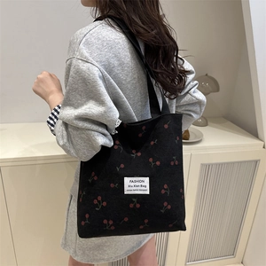 Black corduroy tote bag with red cherry embroidery and shoulder straps for daily use