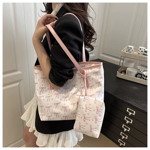 Detailed view of the large tote bag set with pink bow pattern and matching mini pouch