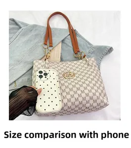 Close-up of printed tote bag featuring logo pattern and mobile phone size comparison