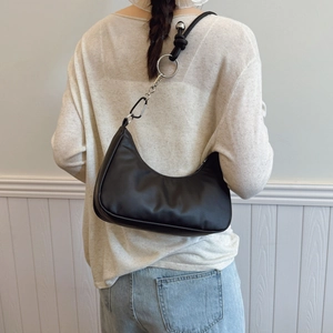 Minimalist black hobo shoulder bag with metal chain detail and knotted strap for women