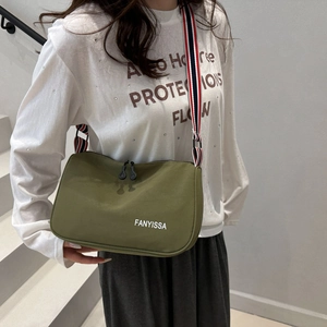 Deep green rectangle crossbody bag with striped wide strap and top double zippers