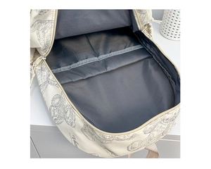 Vue intérieure du sac à dos blanc cassé montrant les compartiments et la doublure grise
