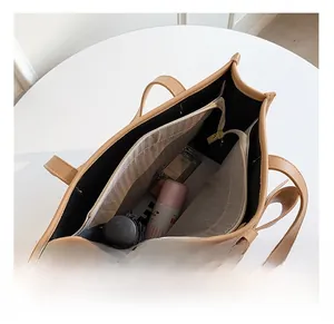 Detail view of the spacious inner compartment with zip pocket in a leather tote bag
