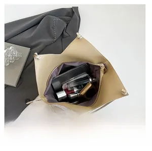 Top view of spacious interior with purple lining in a beige woven tote bag