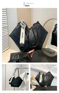 Detail of black woven texture tote with V-cut top and stylish wide logo shoulder strap