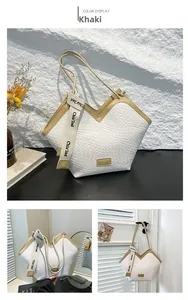 Detail of large tote bag featuring white woven texture, V-shaped cut and khaki leather trim