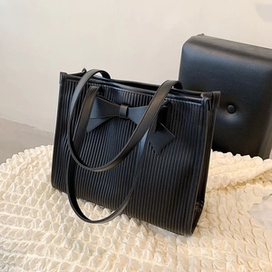 French chic black pleated tote bag with large bow detail and long shoulder straps