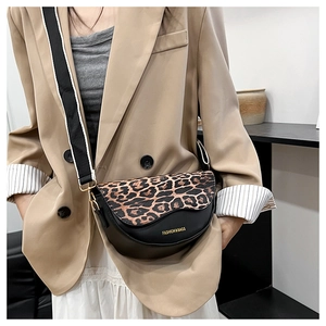 Detail of leopard print flap saddle bag with striped wide strap and logo text