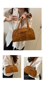 Detail of the brown corset lace-up design on leather shoulder bag with dual handles