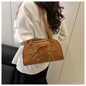 Brown retro pillow shoulder bag with drawstring detail and metallic hardware
