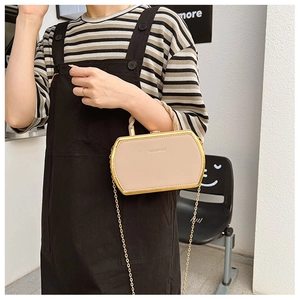 Close-up of small crossbody chain bag in beige leather with gold metal frame