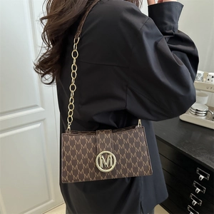 French vintage brown monogram underarm bag with gold M logo and chain shoulder strap