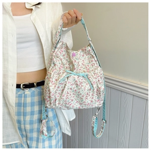 Floral canvas bag detail with blue checkered bow and purple magnetic clasp