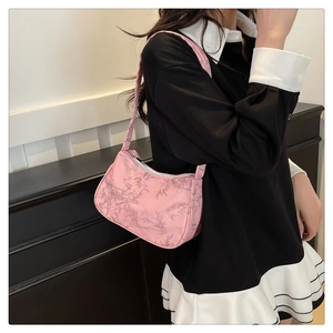 Detailed close-up of pink Hobo bag featuring bamboo leaf prints and woven strap texture