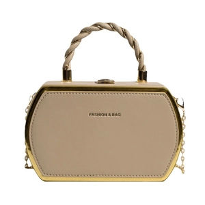 Minimalist beige hexagonal box bag with woven gold chain handle and metal trim