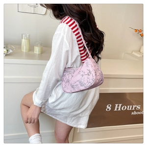 Detail of pink shoulder bag with bamboo leaf pattern worn with white casual shirt