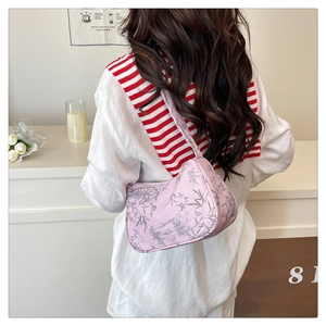 Detailed back view of pink hobo bag with bamboo prints on a model in lifestyle setting