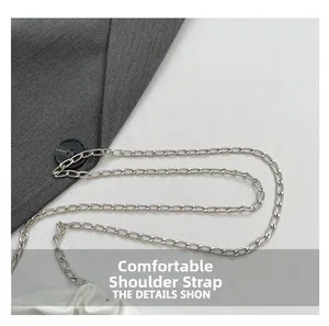 Detail of silver metal chain strap and white pleated leather on a stylish shoulder bag