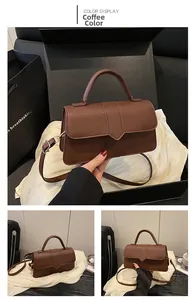 Detail der kaffeebraunen Ledertasche in Premium-Geschenkbox mit goldenen Metallteilen