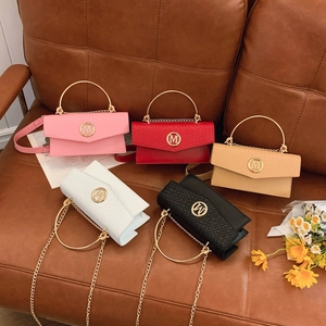 French style contrast woven flap bag set with gold M logo and chain strap on leather sofa
