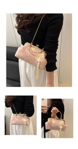 Detail of pink floral brocade shell bag with gold chain strap and elegant white tassel