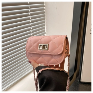 Detailed close-up of pink quilted mini bag with gold chain strap and metal lock