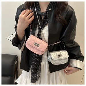 Detail of mini quilted crossbody bags in pink and silver with chain straps on model
