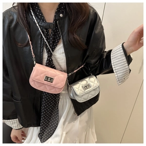 Close-up of mini quilted crossbody bags in pink and silver with chain straps