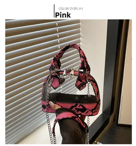 Pink snakeskin trim on transparent shell bag with metal chain strap detail