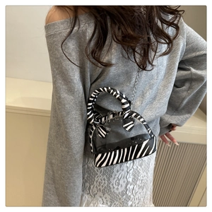 Mini transparent PVC shell bag with zebra print trim worn crossbody on model back