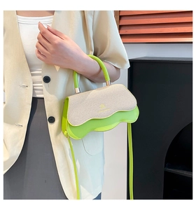 Detail of green and beige patchwork crossbody bag with wavy bottom and woven texture
