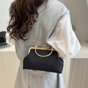 Elegant black polka dot evening bag with gold ring handle and chain strap for women
