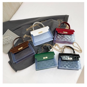 Flat lay of multi-color PVC mini handbags with crocodile texture and gold chain straps
