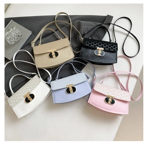 Flat lay of multiple stylish mini box bags featuring decorative T-lock and chain straps