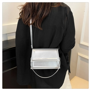 Detalle de bolso bandolera plateado metalizado con acabado perlado en modelo
