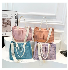 Detail of colorful tote bags with bamboo leaf prints and adjustable wide shoulder straps